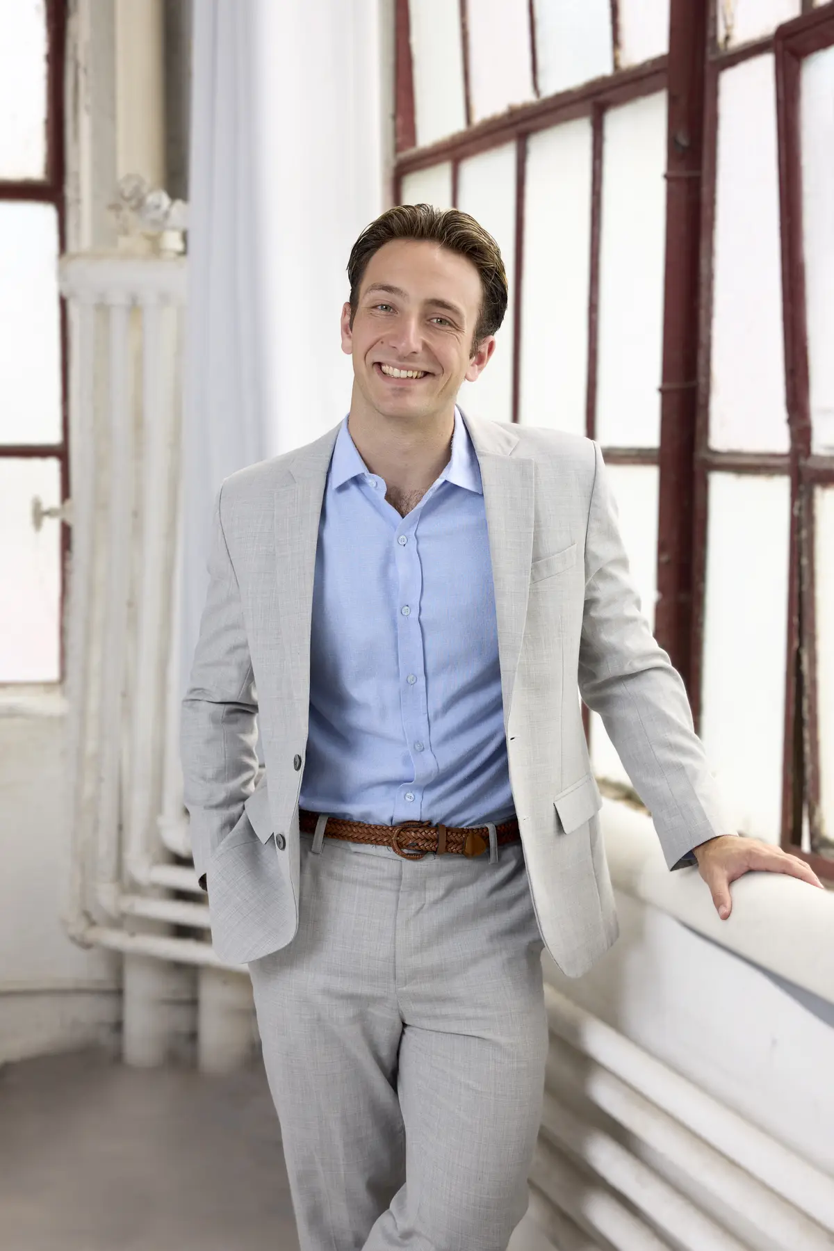 Thomas Hughes standing in a suit